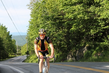 Smiling rider at top of long climb